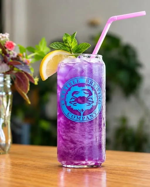 A purple iced drink with garnish at Crabtree Brewing