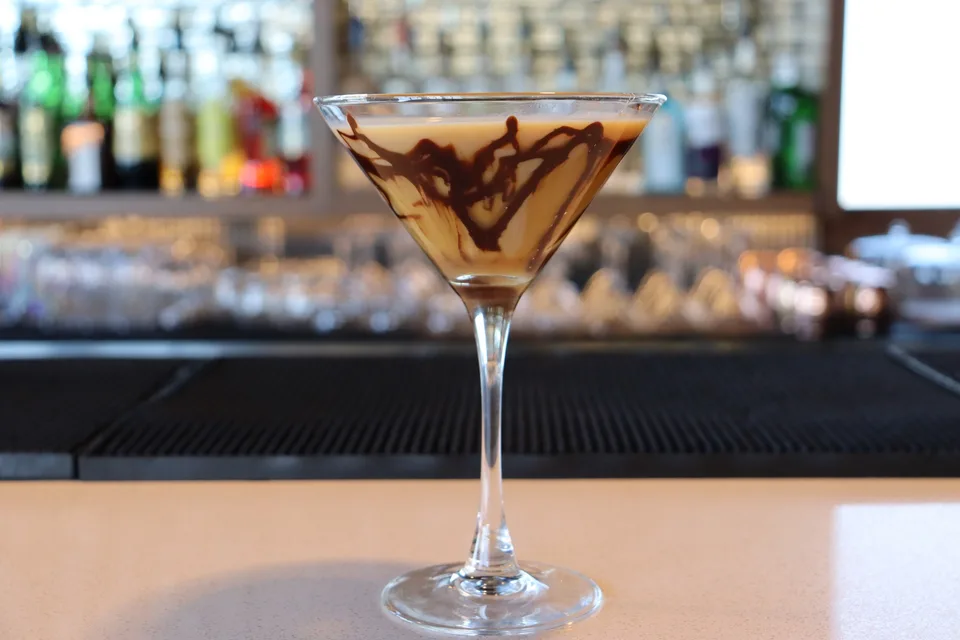 A creamy martini with chocolate drizzle on the glass at Out of the Blue.