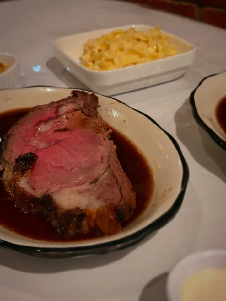 Prime rib served in jus with a side dish at Pinocchios Prime.