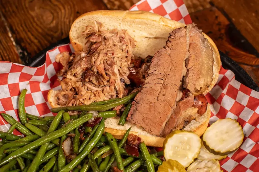 The Pitmaster barbecue sandwich with smoked meats, green beans and sliced pickles at Smokin Dave’s Greeley.