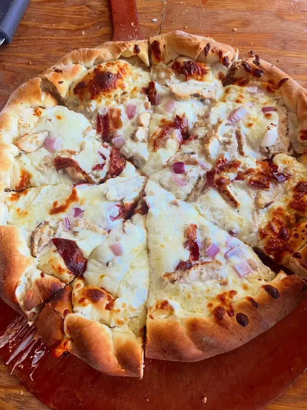 A pizza covered with melted cheese and toppings at The Original Roma.