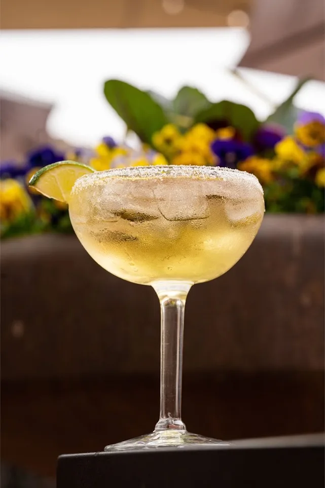 A margarita over ice with a salted rim and lime wedge at Rio Grande Mexican Restaurant.