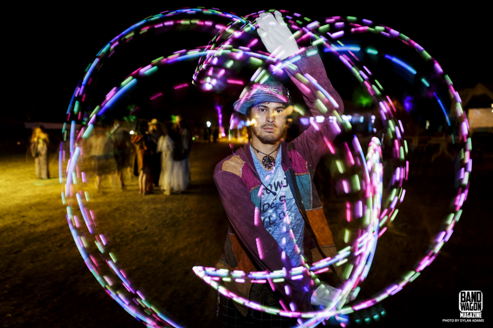 Festival attendee finger-paints light in this long-exposure shot at the Arise Music Festival